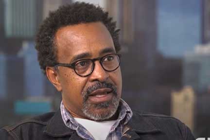 Tim Meadows with black rimmed glasses and a jean jacket